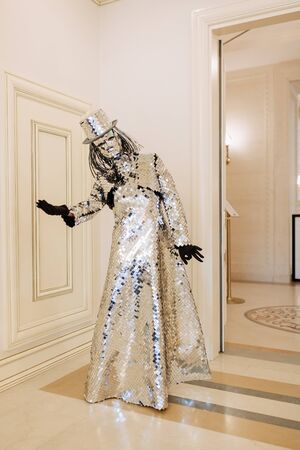 Woman in Bright Performance Mirror Costume and Hatの写真素材