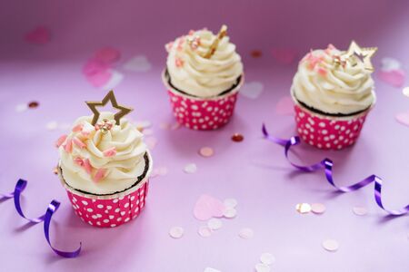 Happy Birthday Cupcakes with Rose Chocolate Chips Decorated Elegant Sweet Balls and Golden Star. Festival Cakes and Celebration Confetti in Heart Shape and Swirl Ribbon. Cooked Food Horizontal Photoの写真素材