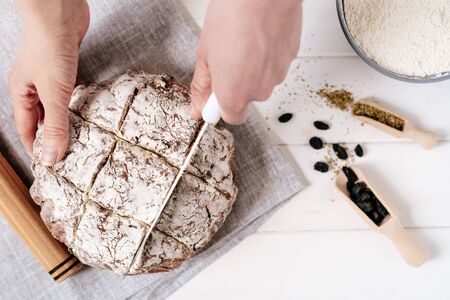 Cutting Bread Loaf with Knife Top View Photographyの写真素材