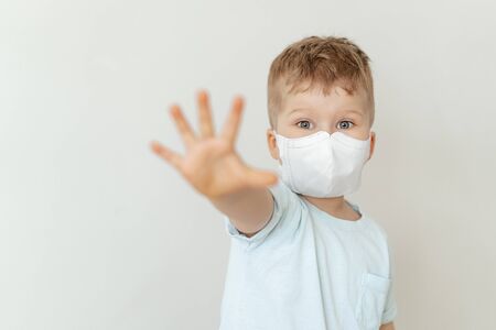 Toddler Boy Wearing Medical Flu Mask Portraitの写真素材