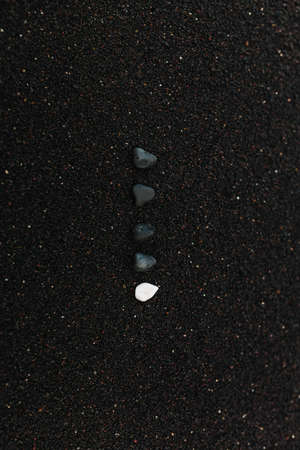Black and White Sea Gravel Row Lies on Beach Sandの写真素材