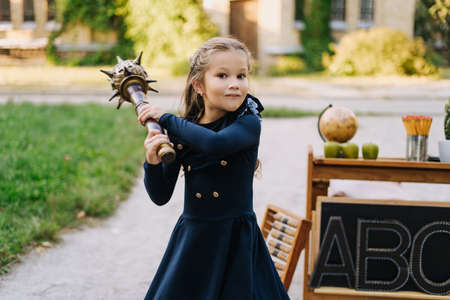 Pretty Schoolgirl Hold Wooden Mace Back-to-schoolの写真素材