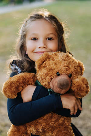 Cute Girl Smile Embrace Toy Teddy Bear Outdoorsの写真素材