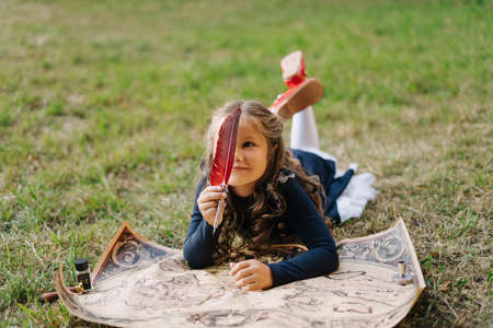 Cute Schoolgirl Hold Quill Pen World Paper Mapの写真素材