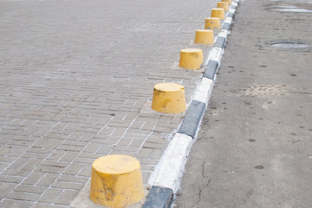 yellow fences at the entrance of cars on the road in the cityの写真素材