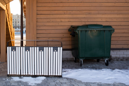 trash bins and a dumpbin on the street