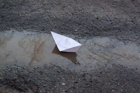 a boat made of white paper runs on the waterの写真素材