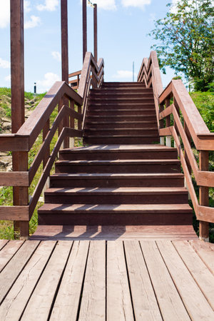 wooden staircase with railings is painted with brown paint