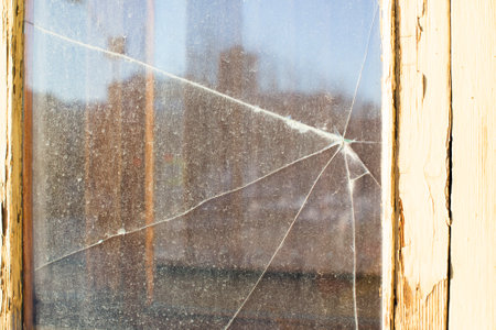 the broken dirty glass in a yellow frameの写真素材