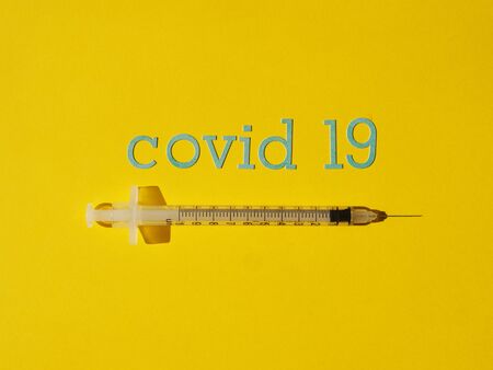 Syringe 1 ml. for insulin on a yellow background for the treatment of Coronavirus Covid19