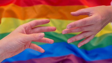 Parody of the mural Creation of Adam on the background of the LGBT flag during the celebration of...