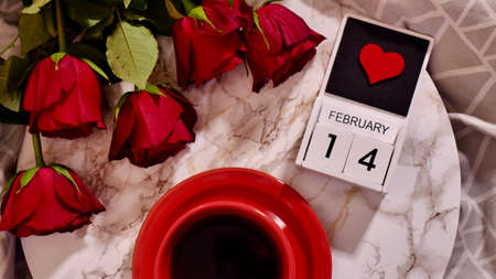 Festive Flatlay, composition for Valentines Day on February 14. Coffee in a red cup and red rose...