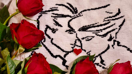 Embroidered picture of a couple in love with black thread with red flowers roses. A wonderful...