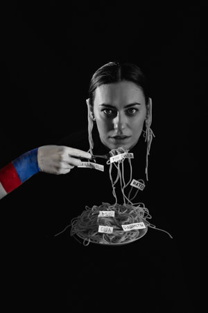 Russian propaganda. Hung spaghetti on the ears. Strangle a woman in war. Black white vertical photo...