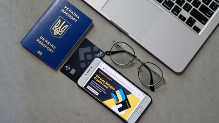 Laptop and phone to buy bitcoin on the Binance crypto exchange for support Ukraine during the market...