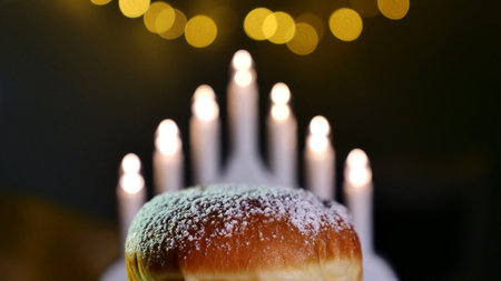 A sweet donut sprinkled with powder sugar for the Jewish holiday of Hanukkah at home. Close upの写真素材