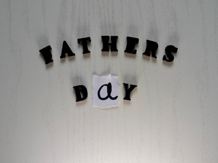 Lettering father in black letters on grey background on fathers day close-upの写真素材