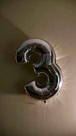 Party Happy Birthday Three with Silver Grey number . Gel balls 3 for congratulations celebrations holiday. Close-up, no people, verticalの写真素材