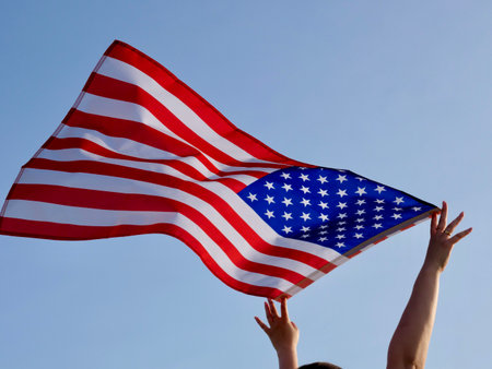 Independence Day American flag against the background of the blue sky blowing in the wind. close upの写真素材