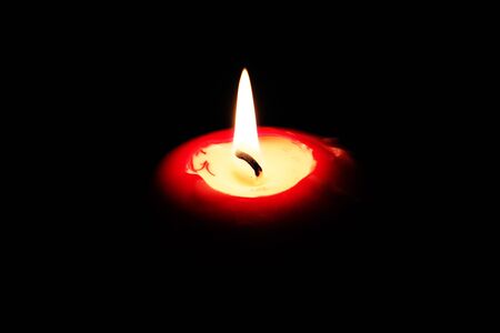 The candle flame on the black backgroundの写真素材