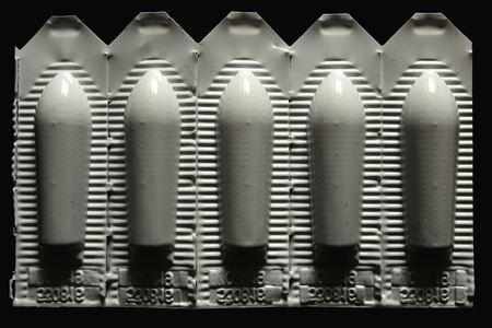 White pack of suppositories isolated on black backgroundの写真素材