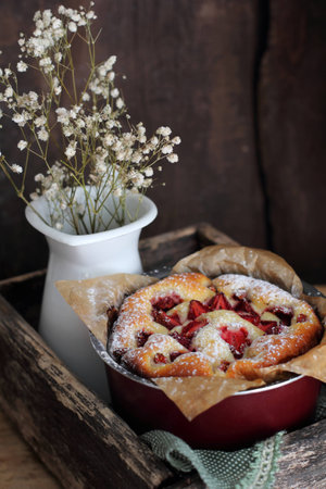 homemade strawberry tart in a baking dish, shot with natural lightの写真素材
