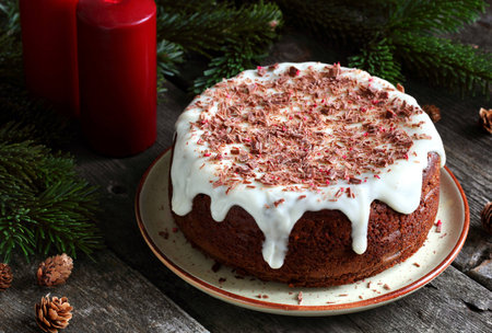 homemade cake with persimmon, decorated with frosting cream cheese and sprinkled with chocolate, in the New Year decorationsの写真素材