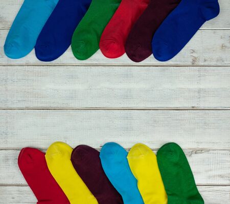 Multi-colored socks on a white background with a tree