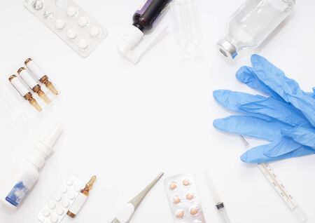 Medicine bottle for injection, pills and thermometer. Medical glass vials and syringe for vaccination. Drug or vaccine for treatment, flu in laboratory, hospital, healthcare, or pharmacy conceptの写真素材
