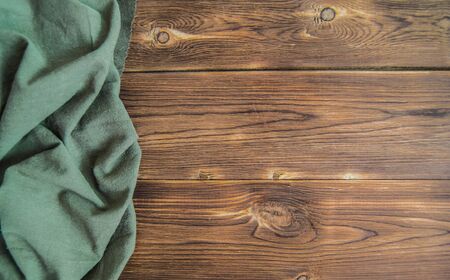Wooden background of knocked down boards with a green napkin