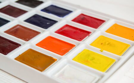 Bright watercolor paint closeup on a light background