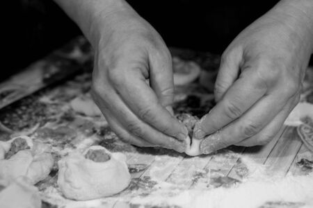 How not to get bored at home during quarantine and isolation? Hobbies for cooking belyashes according to Ukrainian recipe Step 5. Modeling with hands and shaping each belyash.の写真素材