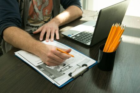 Online lesson. Hands of a young man during online training. Quarantineの写真素材
