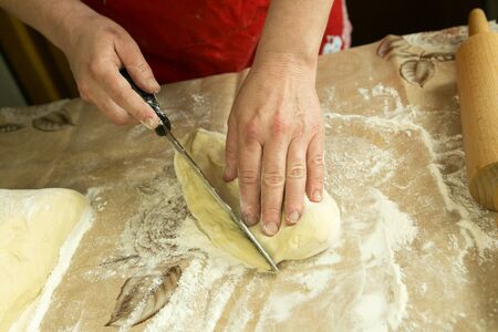Mom's pies. Mom works with a baking dough. Mom's hands. Cooking during quarantine.