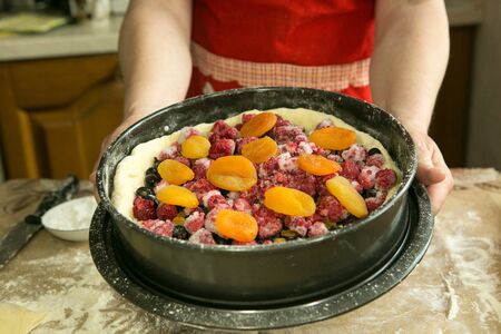 Mom's pies. Dough and fruit topping are in a baking dish. Cooking during quarantine.の写真素材