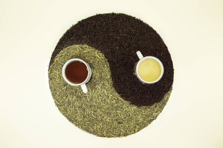 Sign Yin Yang with tea. Used Chinese black tea and green Lundzin. Black tea and Lundzin are brewed in cups. Healthy eating concept.の写真素材