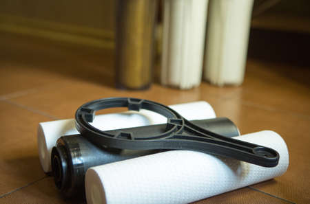 Changing filters in your home water purification system. The new filters are 5 microns, 1 micron and...