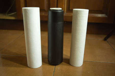 Changing filters in your home water purification system. The filters of the three degrees of...