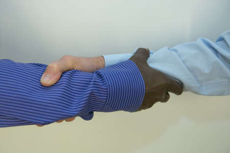Black lives matter. Close up photo of a handshake between afroamerican and european hands.
