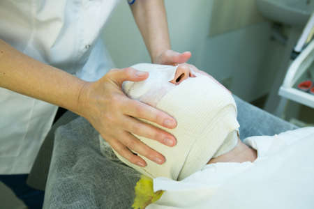 A visit to a beautician. The doctor is fixing the mask. The procedure is carboxytherapy.