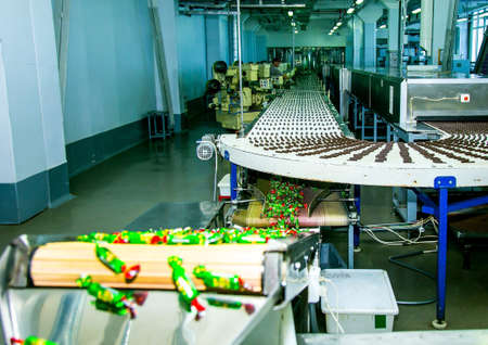 Sweets factory. Sweets production process. Conveyor belt with sweets on it.