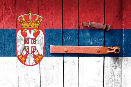 Serbia flag is on texture. Template. Coronavirus pandemic. Countries are closed. Locks.の写真素材