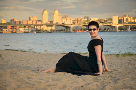 Picture of a middle-aged woman. Concept of emotions. Woman is happy to have rest outdoors after quarantine is relaxed.の写真素材