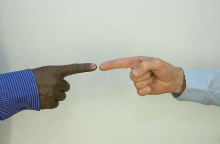 Close up photo of a hand gestures between afroamerican and european hands.の写真素材