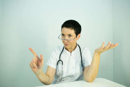 Doctor is a beautician. Portrait of a middle-aged woman. The doctor tells the patient about the need...