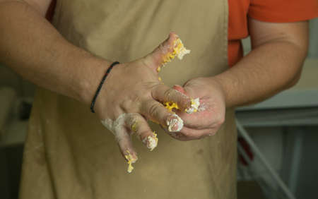 Healthy food concept. The process of making natural egg noodles. The chef's hands are kneading the...
