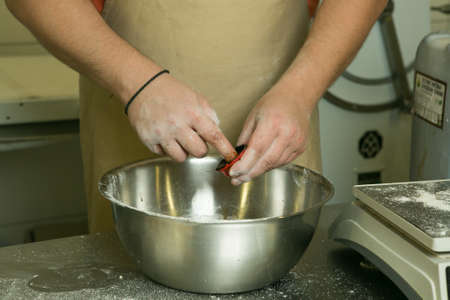 The process of making bread. The chef kneads the dough by hand. The chef's hands prepare the malt to...