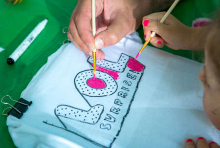 Drawing lesson. Children's hands. Children learn to paint.