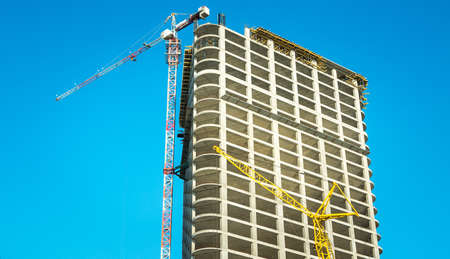 New building. Construction of new buildings. Construction cranes used for the construction of new...
