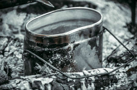 Picnic. Cooking food over an open fire. We heat water over a fire for tea and coffee. Camping with closed borders. Due to the coronavirus, you cannot travel abroad.の写真素材